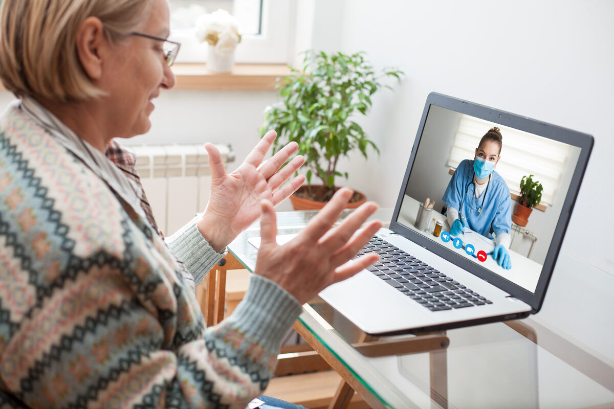 A woman speaks with a healthcare professional over a video call